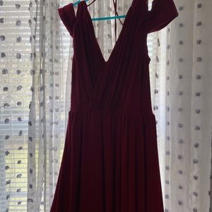 Red dress with drape on shoulders. Flirtatious breezy romantic